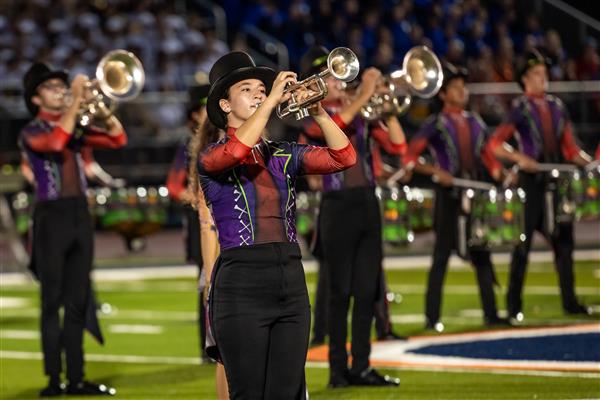 Ravenwood High band members march